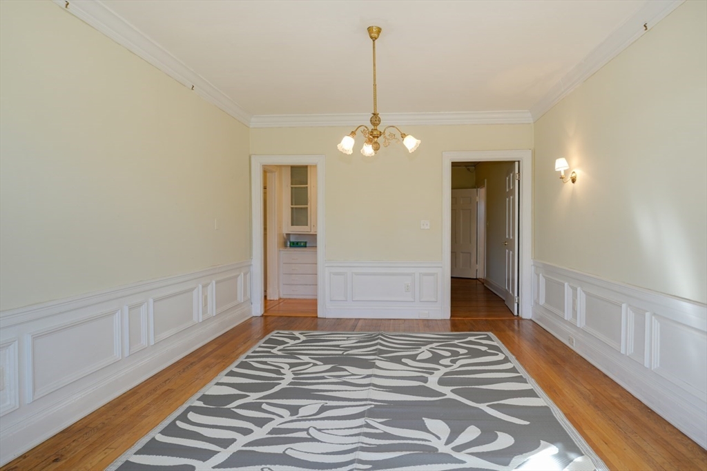 983 Memorial Drive, Unit 502 Cambridge, MA 02138 - Photo 17 of 33 a view of a hallway with wooden floor and a chandelier
