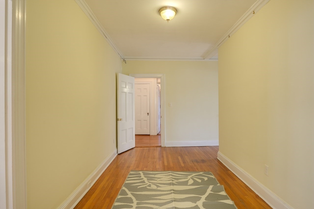 983 Memorial Drive, Unit 502 Cambridge, MA 02138 - Photo 20 of 33 a view of a room with wooden floor and brick wall