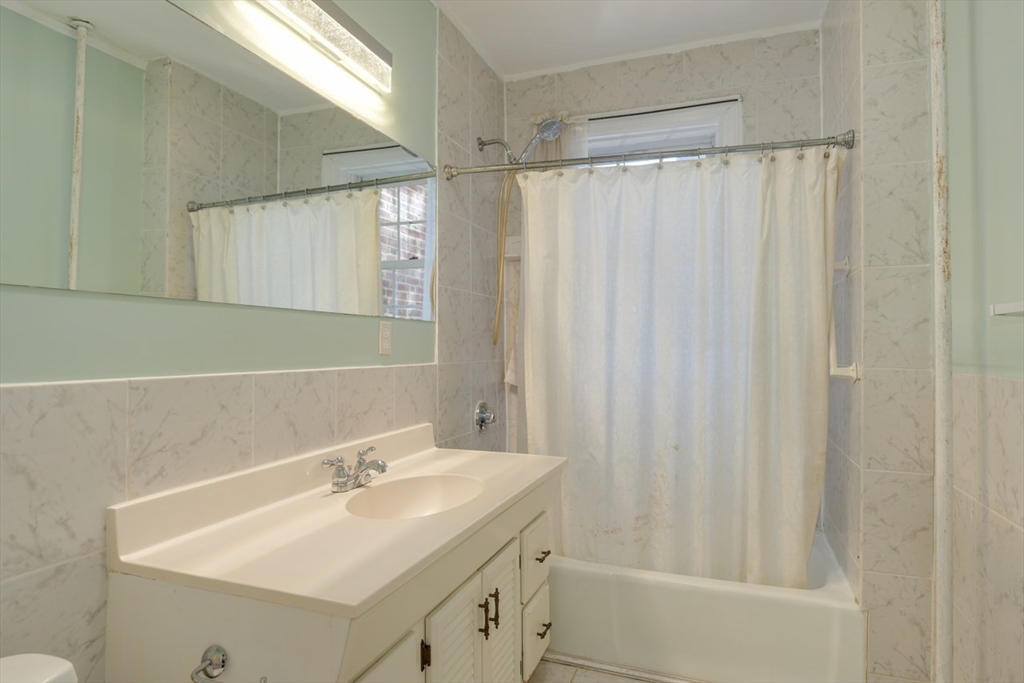 983 Memorial Drive, Unit 502 Cambridge, MA 02138 - Photo 25 of 33 a bathroom with a sink and a mirror