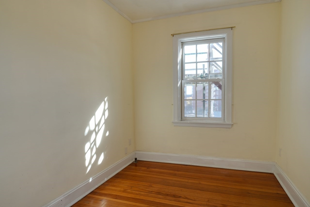983 Memorial Drive, Unit 502 Cambridge, MA 02138 - Photo 26 of 33 an empty room with wooden floor and windows