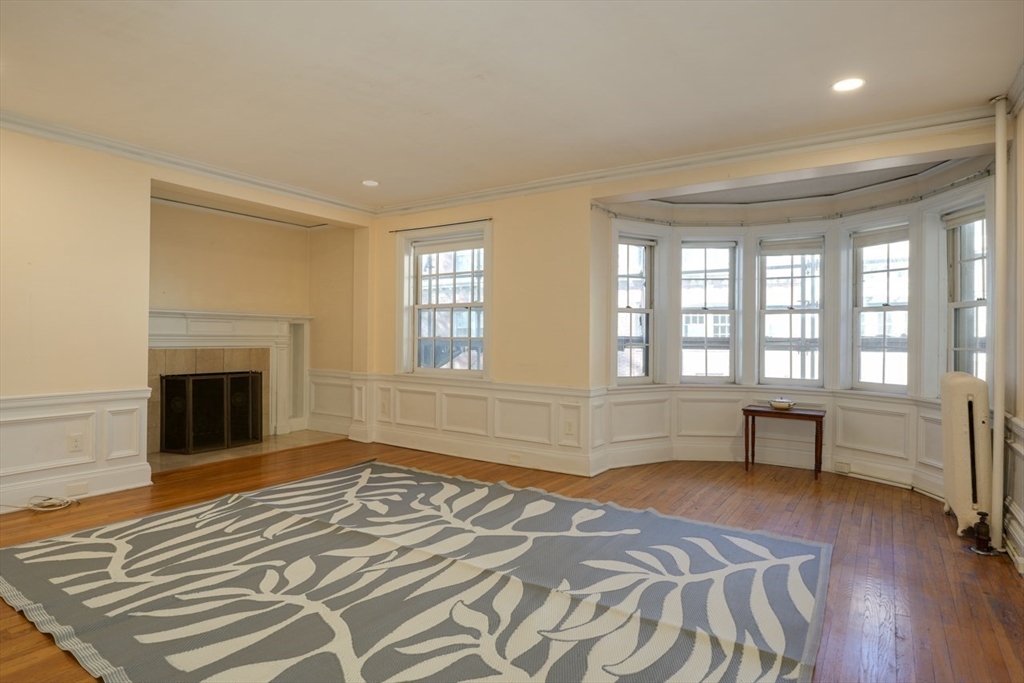 983 Memorial Drive, Unit 502 Cambridge, MA 02138 - Photo 4 of 33 a bedroom with a bed and a fireplace