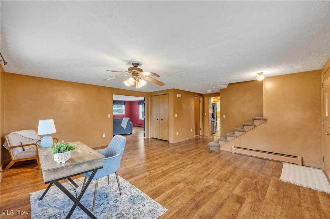 506 Logan Road Mansfield, OH 44907 - Photo 5 of 46 Office featuring baseboard heating, a textured ceiling, wood finished floors, and ceiling fan