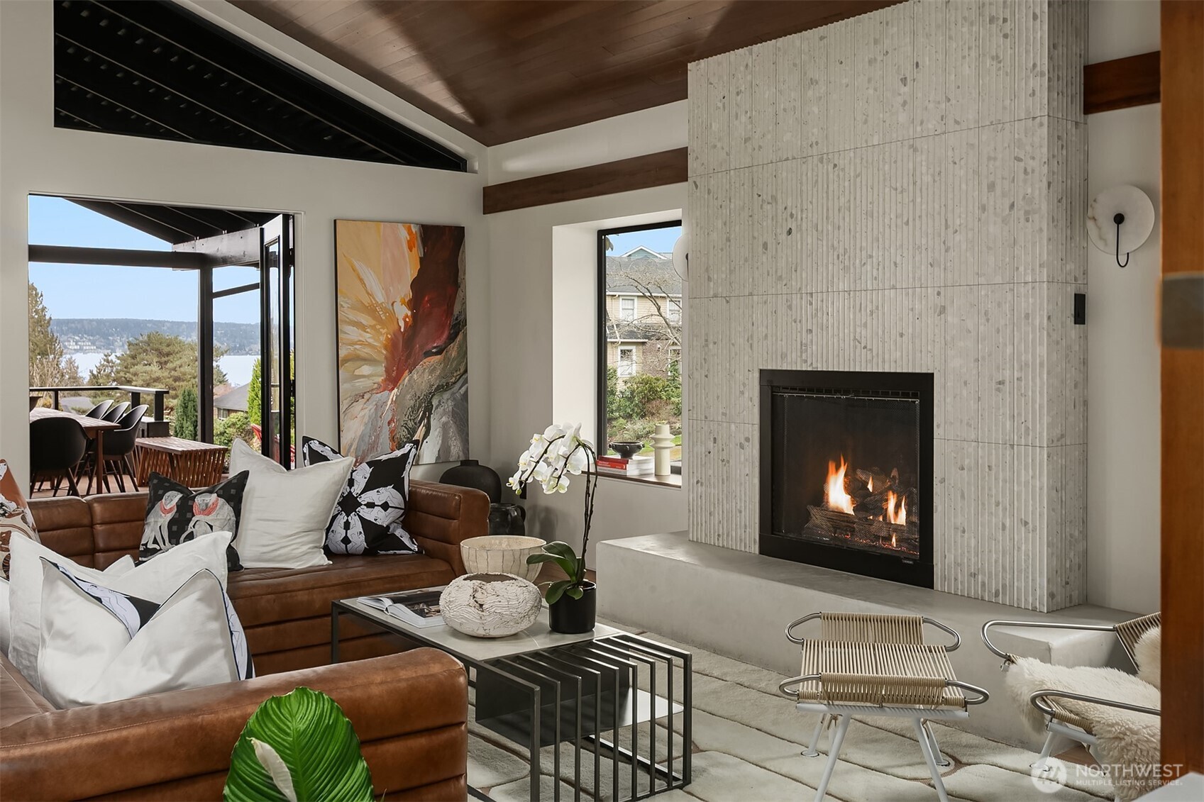 5010 Northeast 52nd Street Seattle, WA 98105 - Photo 14 of 40 a living room with furniture a fireplace a large window and a flat screen tv