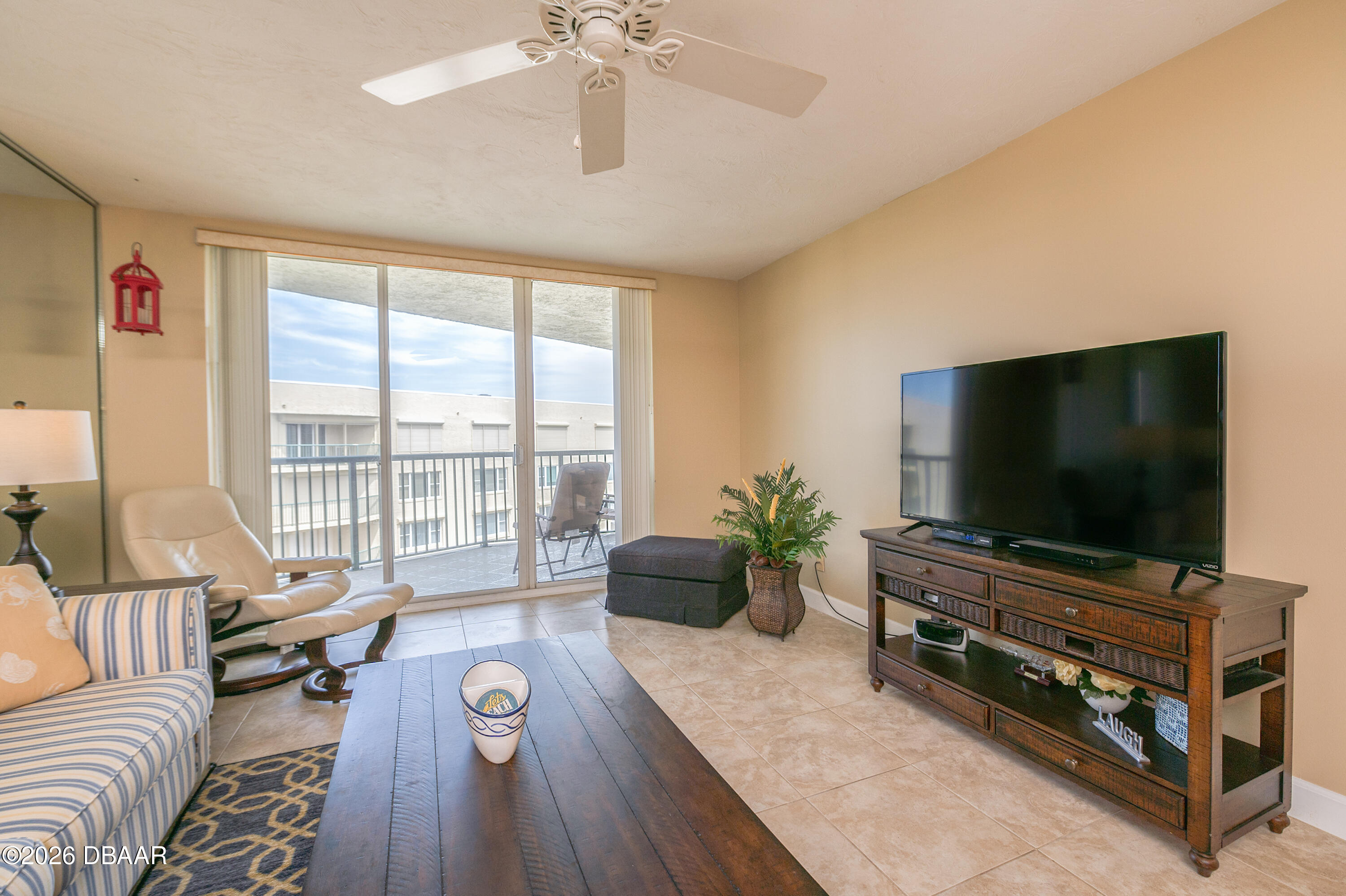 4575 South Atlantic Avenue, Unit 6701 Ponce Inlet, FL 32127 - Photo 6 of 35 a living room with furniture and a flat screen tv