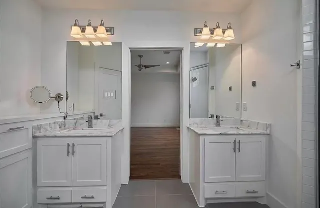a bathroom with a double vanity sink and a mirror
