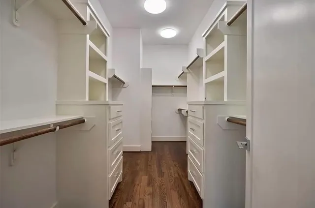 a view of walk in closet with empty racks