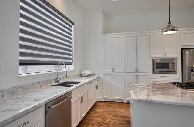 a kitchen with a sink and a refrigerator