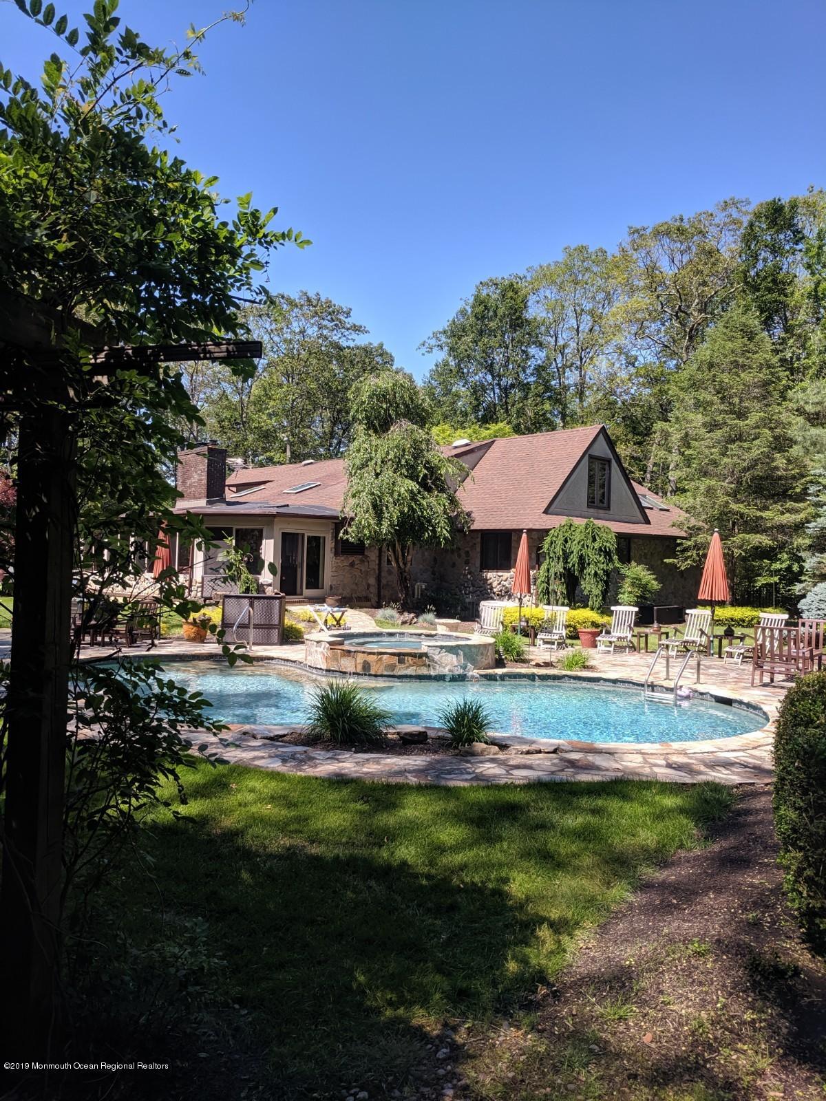 9 Beaver Hill Road Morganville, NJ 07751 - Photo 49 of 50 a view of swimming pool and trees in the background