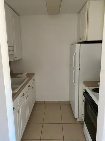a kitchen with a stove and a refrigerator