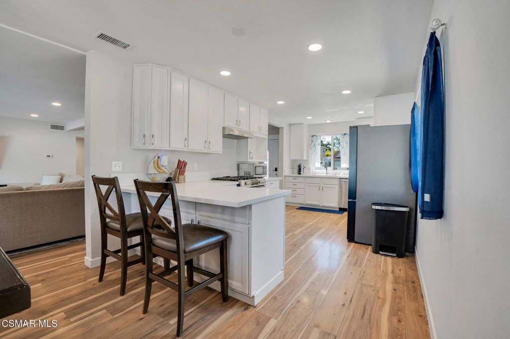 926 Talbert Avenue Simi Valley, CA 93065 - Photo 13 of 41 a kitchen with a table and chairs in it