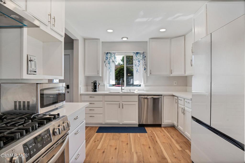 926 Talbert Avenue Simi Valley, CA 93065 - Photo 15 of 41 a kitchen with a white stove top oven and sink