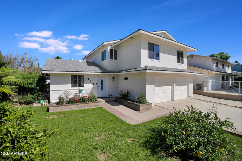 926 Talbert Avenue Simi Valley, CA 93065 - Photo 2 of 41 a front view of a house with a yard and garage