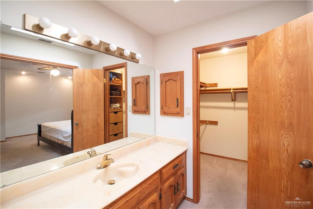 401 Taurus Street Mission, TX 78572 - Photo 14 of 18 a bathroom with a tub sink and mirror
