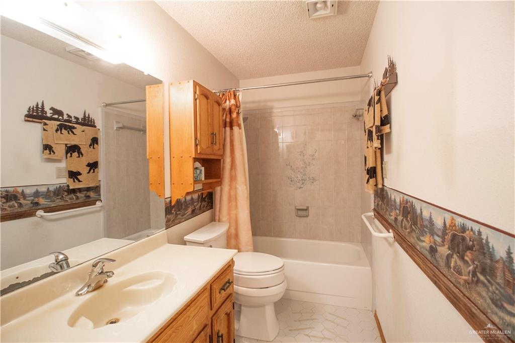 401 Taurus Street Mission, TX 78572 - Photo 17 of 18 a bathroom with a sink toilet and shower