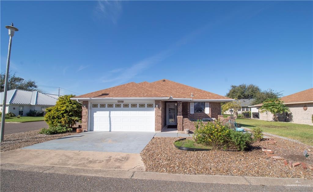401 Taurus Street Mission, TX 78572 - Photo 2 of 18 a front view of a house with a garden