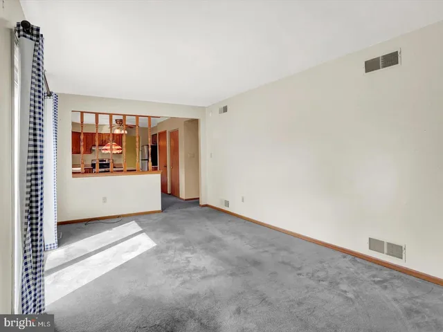 a view of a room with a window and a kitchen