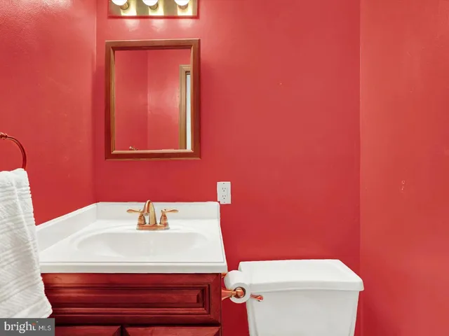 a bathroom with a sink a toilet and mirror