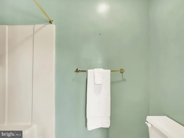 a utility room with a refrigerator and a sink