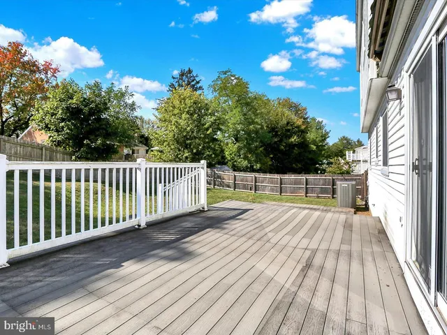 a view of balcony with wooden floor and fence