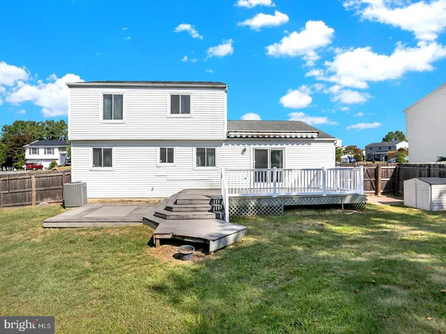a view of a house with swimming pool and sitting area