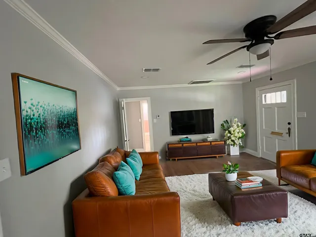 a living room with furniture and a flat screen tv