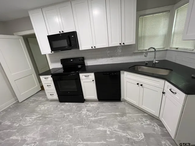 a kitchen with stainless steel appliances granite countertop a sink stove and cabinets