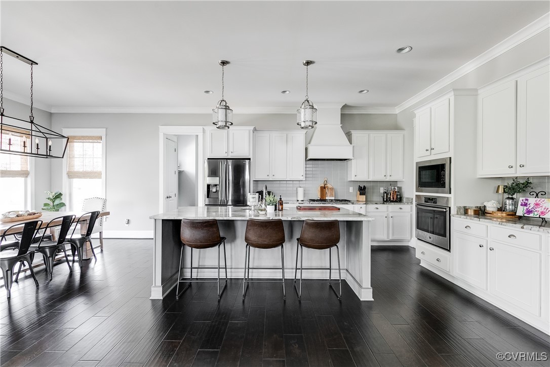 16506 Binley Road Midlothian, VA 23112 - Photo 18 of 49 a kitchen with stainless steel appliances kitchen island granite countertop a dining table chairs and sink