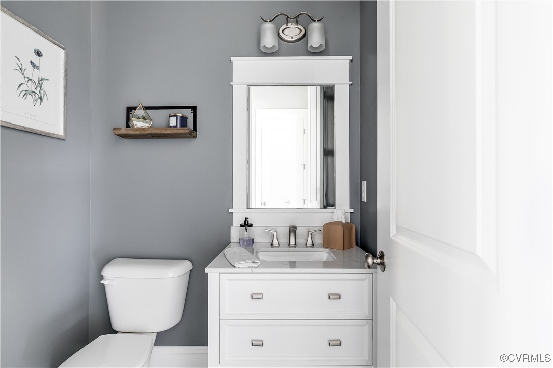 16506 Binley Road Midlothian, VA 23112 - Photo 25 of 49 a bathroom with a toilet sink vanity and mirror