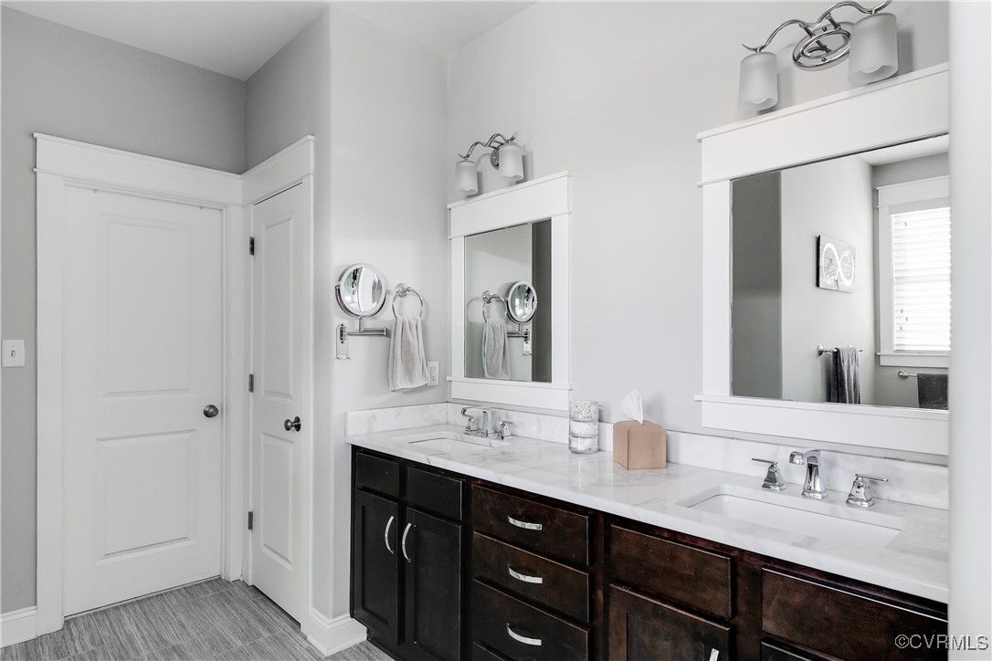 16506 Binley Road Midlothian, VA 23112 - Photo 31 of 49 a bathroom with double vanity sinks a vanity two mirror and a shower