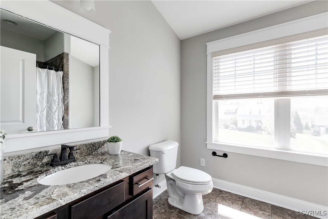 16506 Binley Road Midlothian, VA 23112 - Photo 44 of 49 a bathroom with a granite countertop sink toilet a large mirror and a window