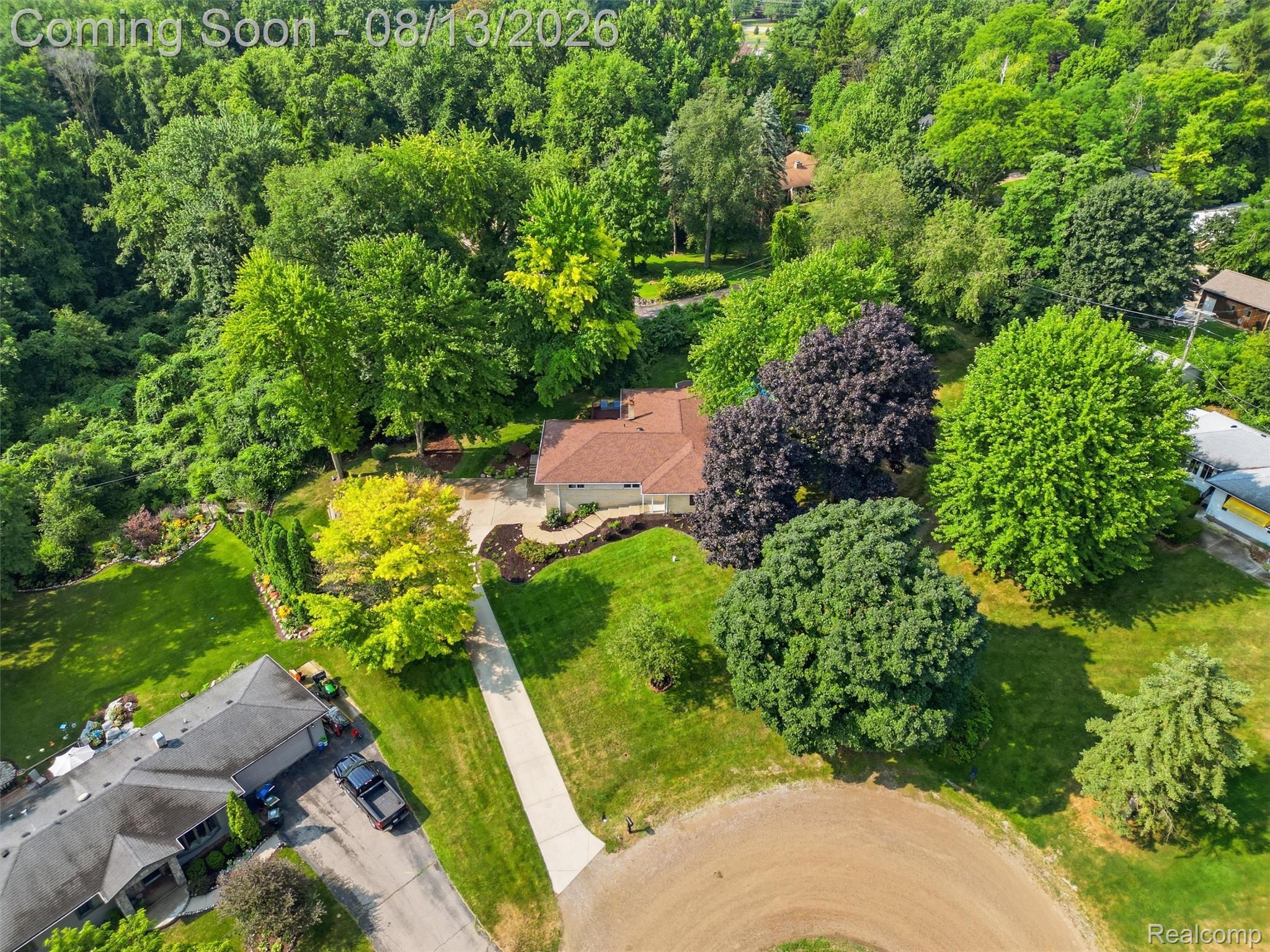 197 Perrydale Street Rochester, MI 48306 - Photo 47 of 50 Expansive grounds showcasing mature trees, manicured lawns, and a brick-paved courtyard