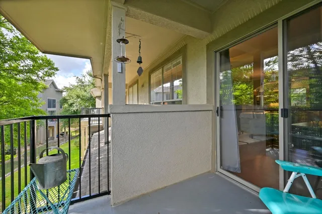 a view of a balcony with furniture