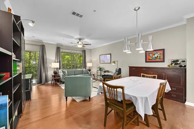 a view of a dining room with furniture window and wooden floor