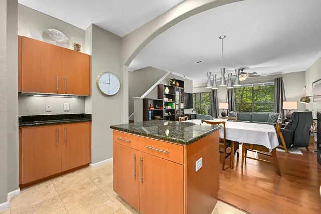 a kitchen with stainless steel appliances granite countertop a stove and a wooden floors