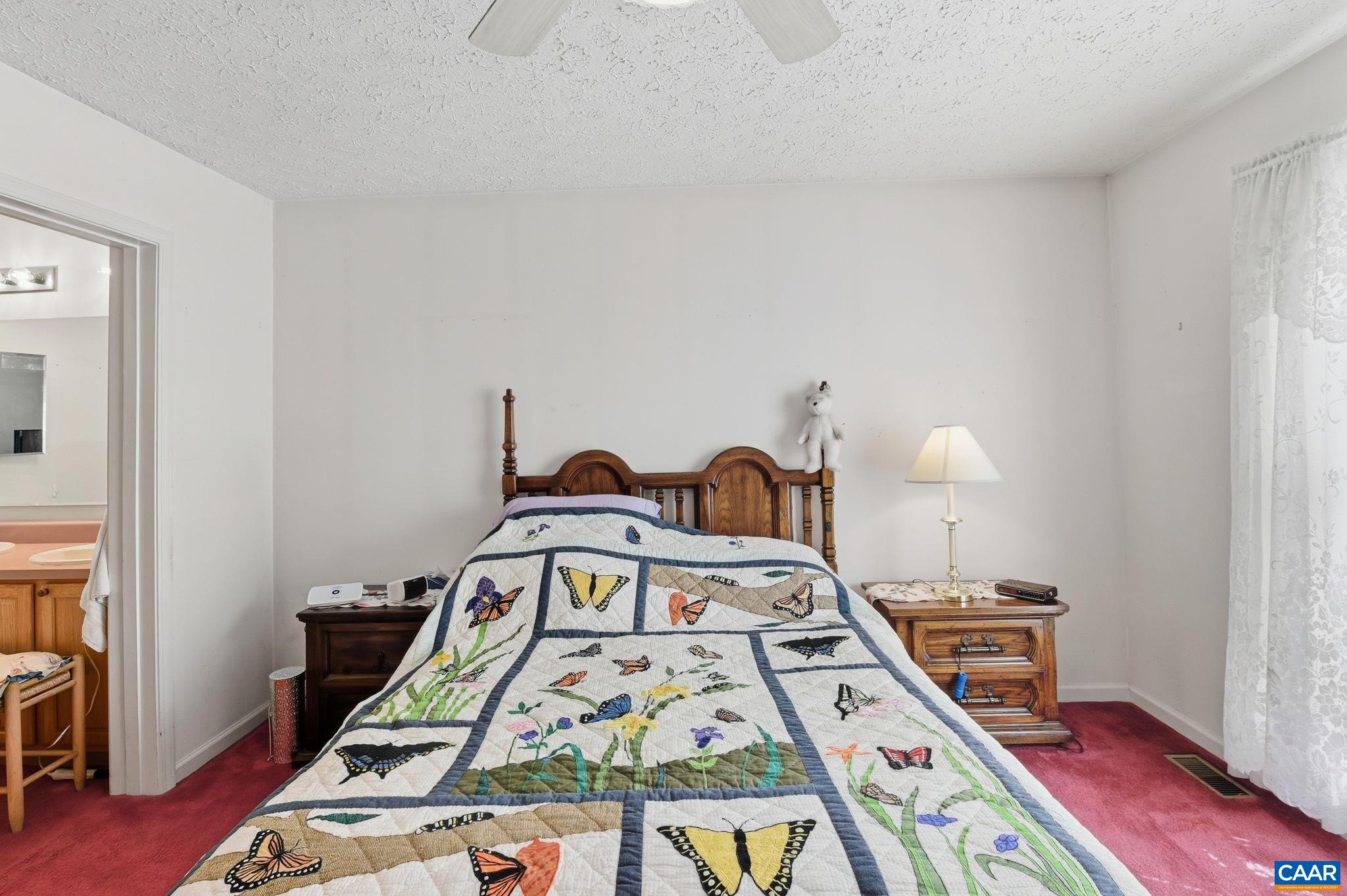 16070 Burnley Road Barboursville, VA 22923 - Photo 12 of 37 a bed sitting in a bedroom next to a window with pc on the table