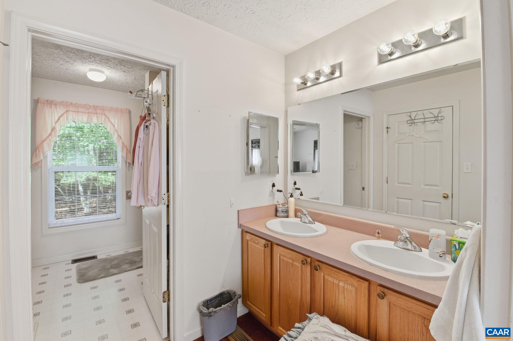 16070 Burnley Road Barboursville, VA 22923 - Photo 14 of 37 a bathroom with a sink double vanity granite tub and a mirror