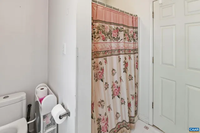a bathroom with a shower curtain and a curtain