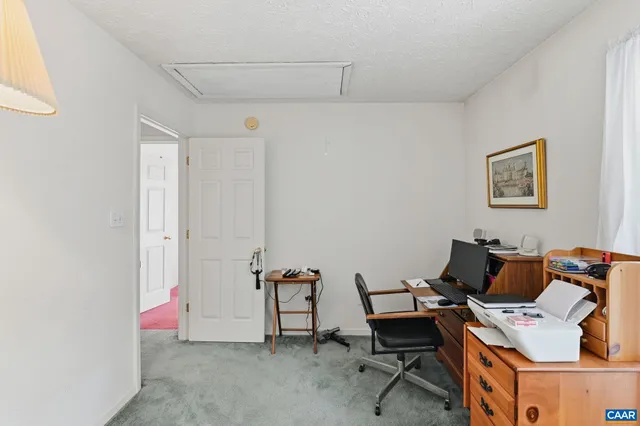 a workspace with furniture and white walls