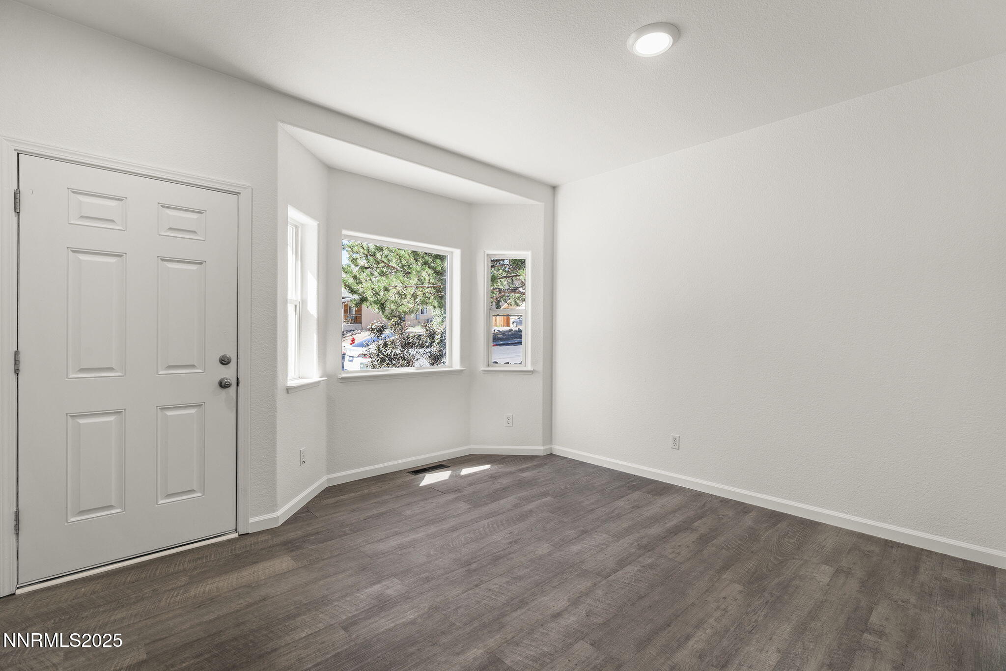 515 College Drive Reno, NV 89503 - Photo 3 of 25 an empty room with wooden floor closet and windows