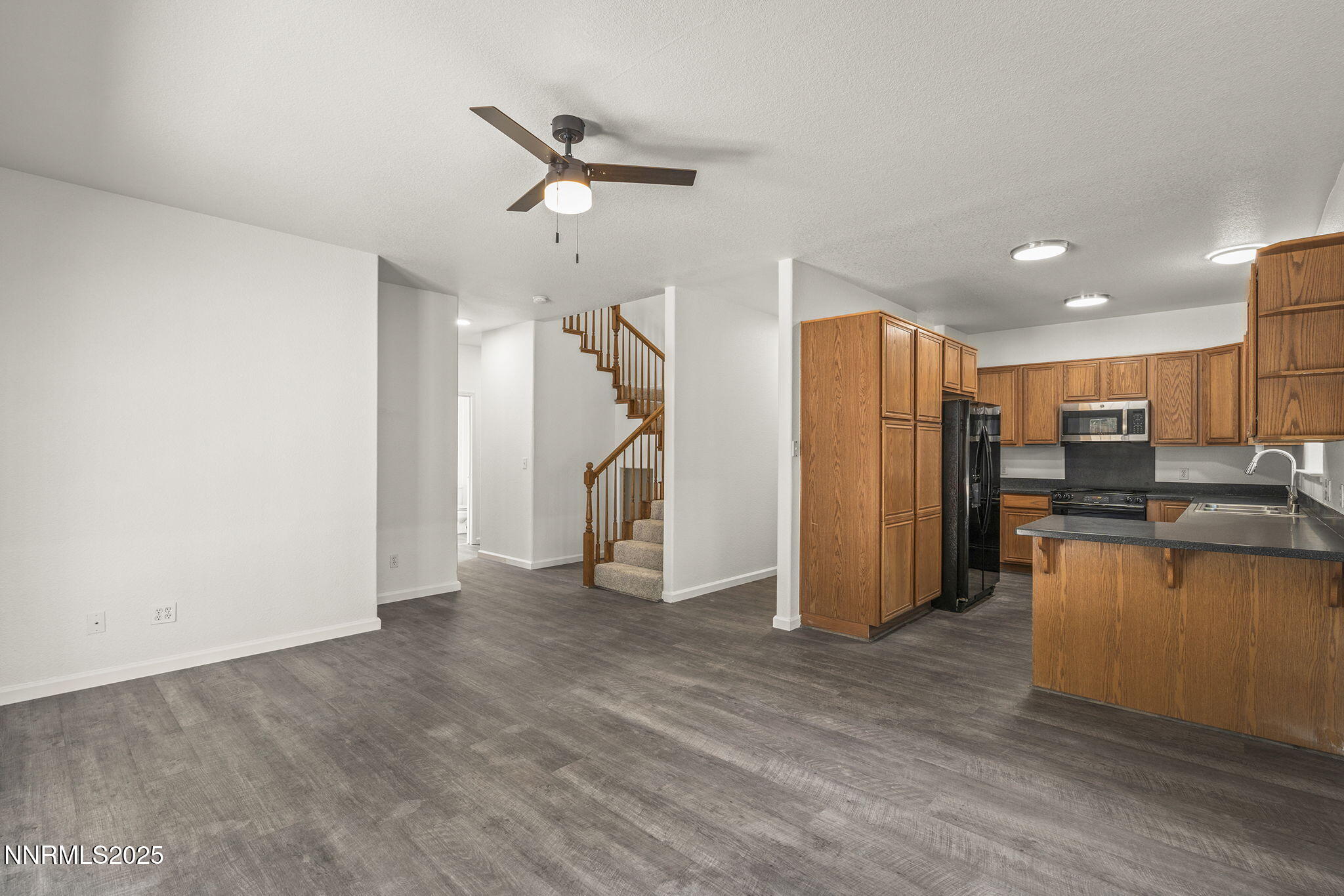 515 College Drive Reno, NV 89503 - Photo 6 of 25 a view of a kitchen with a refrigerator wooden floor and a ceiling fan