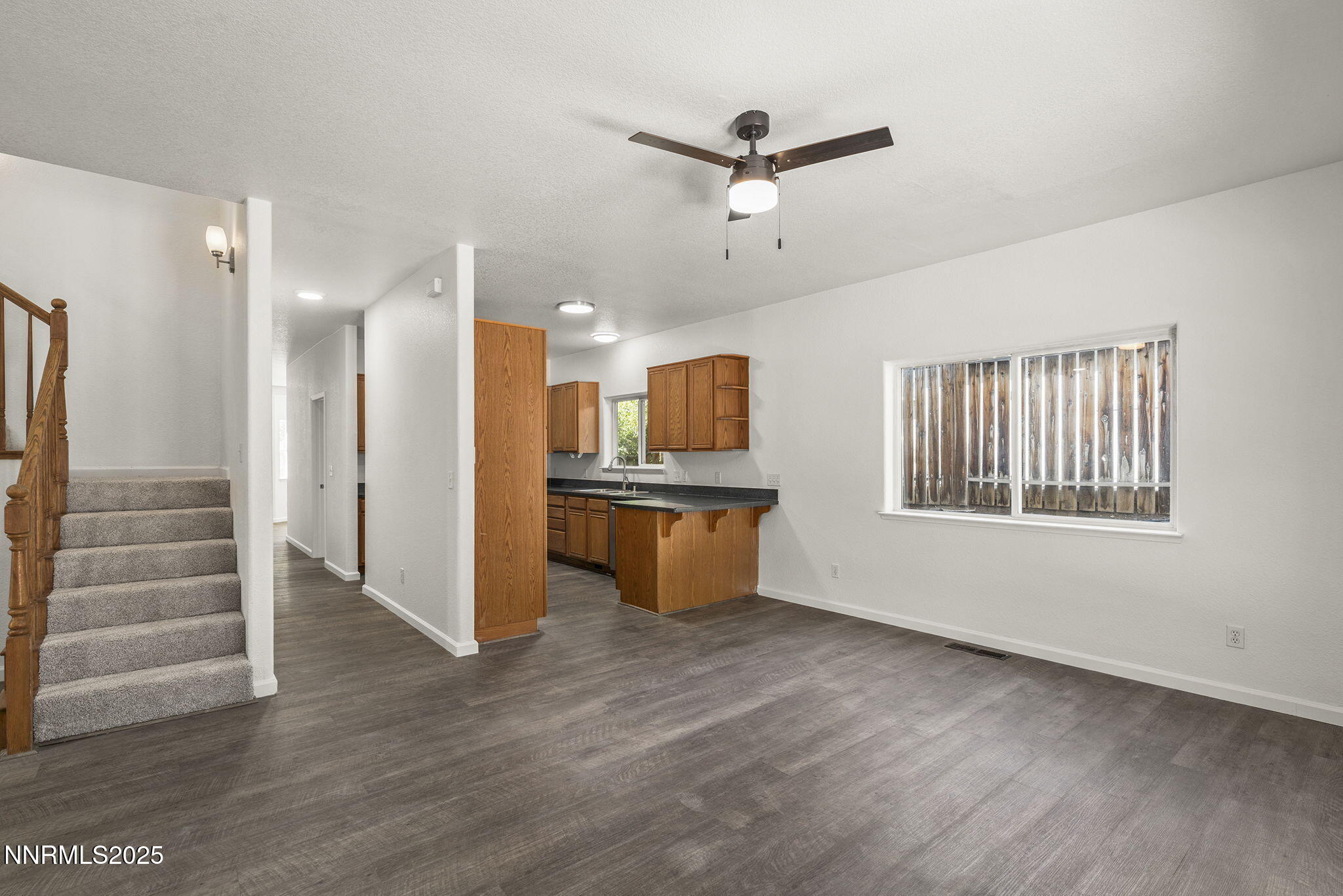 515 College Drive Reno, NV 89503 - Photo 7 of 25 a view of an empty room with a window and wooden floor
