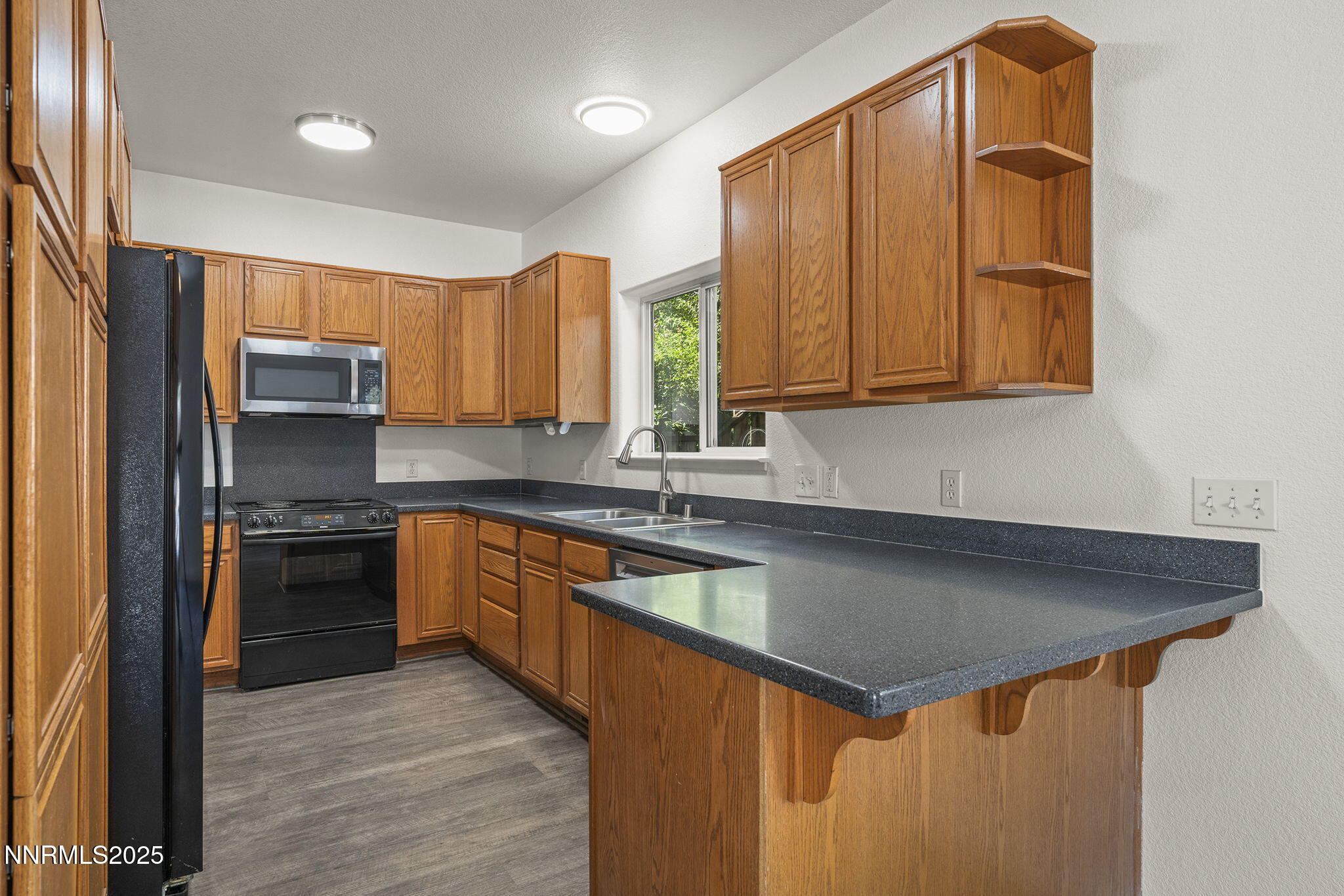 515 College Drive Reno, NV 89503 - Photo 8 of 25 a kitchen with stainless steel appliances granite countertop a sink stove and refrigerator