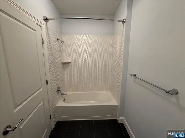 a bathroom with a bathtub and shower