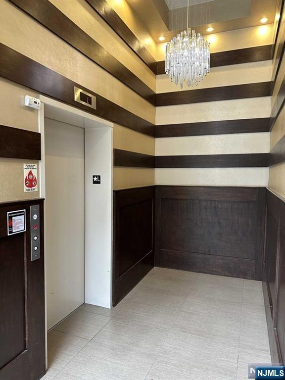 2001 Hudson Terrace, Unit 404 Fort Lee, NJ 07024 - Photo 20 of 21 a view of a hallway with a chandelier