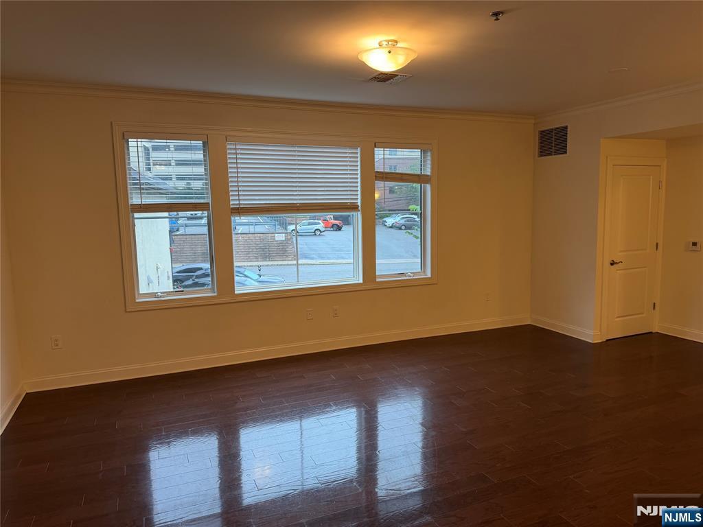 2001 Hudson Terrace, Unit 404 Fort Lee, NJ 07024 - Photo 4 of 21 a view of an empty room with wooden floor and a window