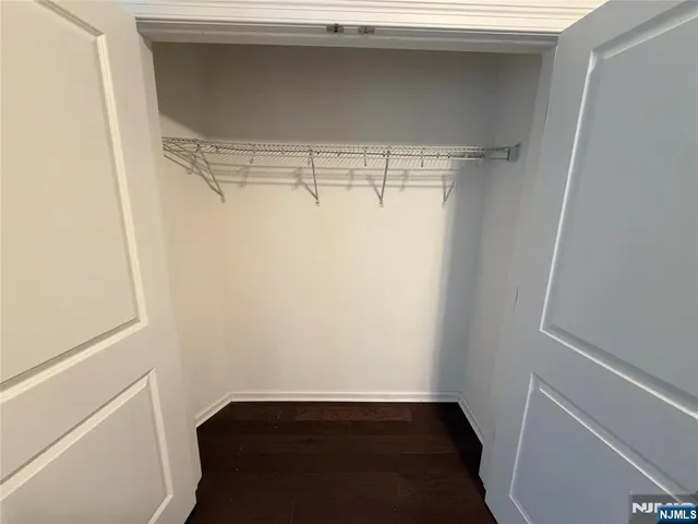 a view of storage and utility room with wooden floor