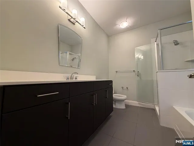 a bathroom with a double vanity sink toilet and a mirror