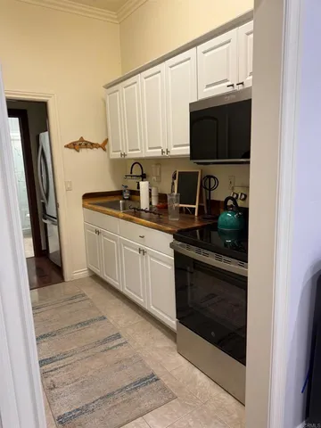 a kitchen with stainless steel appliances granite countertop a stove microwave and sink