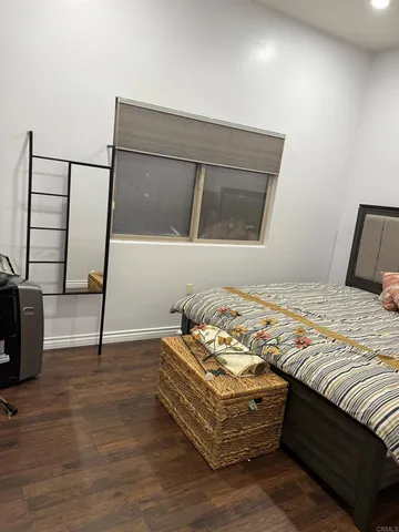 a bedroom with bed and a window