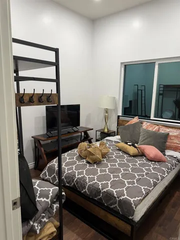 a bedroom with a bed and a flat screen tv